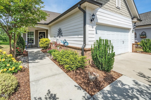 view of front of home with a shingled roof and driveway