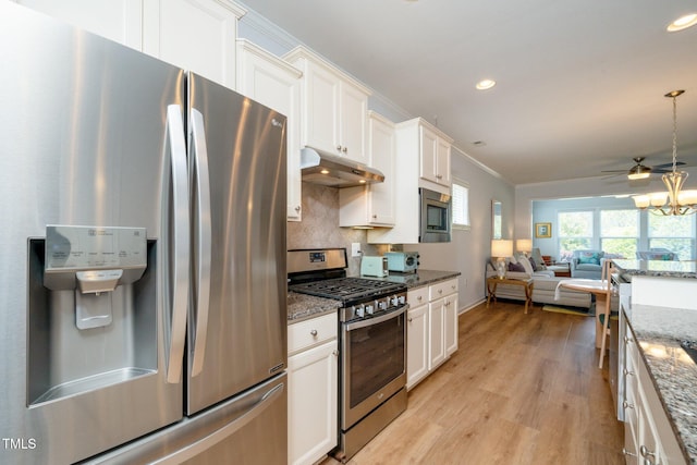 kitchen with white cabinets, appliances with stainless steel finishes, light wood finished floors, open floor plan, and under cabinet range hood