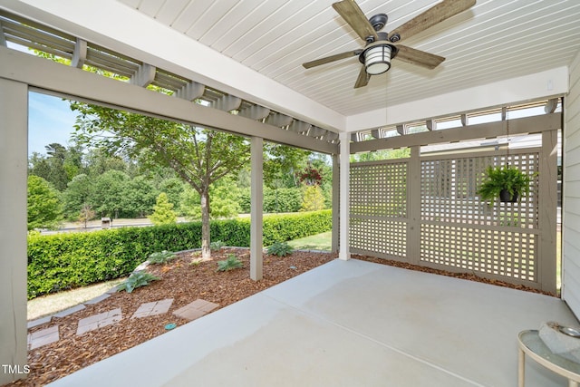 unfurnished sunroom with ceiling fan