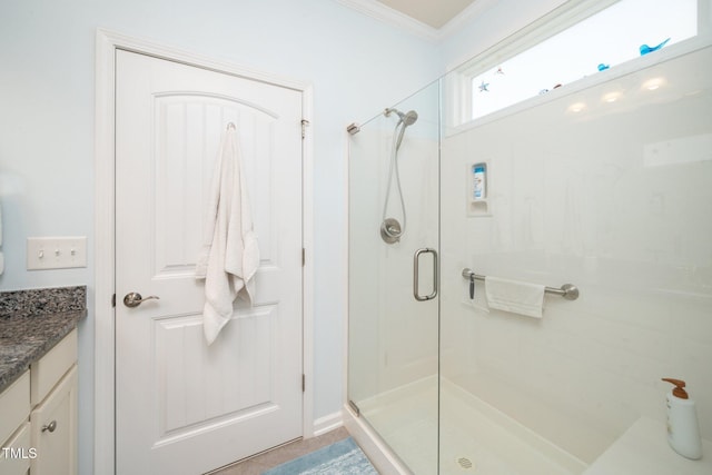 bathroom with vanity, ornamental molding, and a stall shower