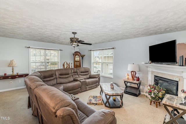 8404 Frenchorn Ln, Fayetteville, NC 28314 - carpeted living room with a tiled fireplace, a ceiling fan, baseboards, and a textured ceiling