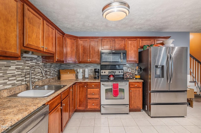 8404 Frenchorn Ln, Fayetteville, NC 28314 - kitchen with backsplash, appliances with stainless steel finishes, a textured ceiling, and a sink