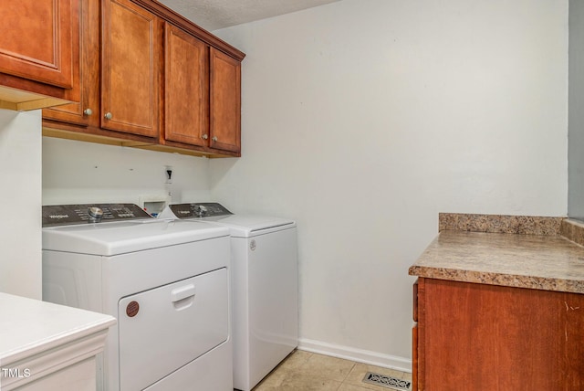 8404 Frenchorn Ln, Fayetteville, NC 28314 - washroom with light tile patterned floors, baseboards, cabinet space, and washer and clothes dryer