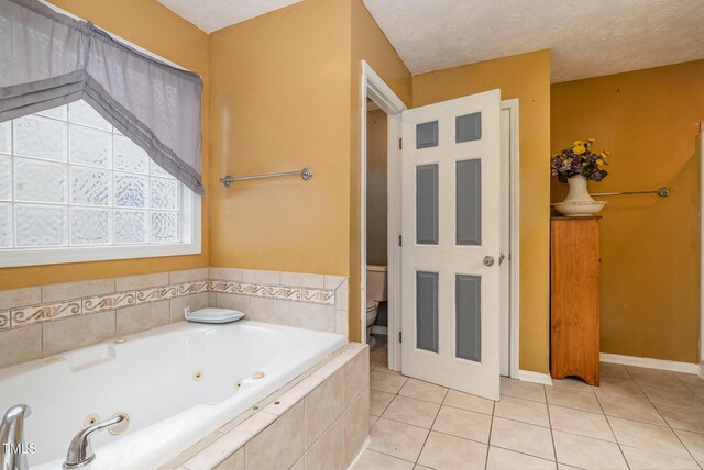 8404 Frenchorn Ln, Fayetteville, NC 28314 - full bath featuring tile patterned flooring, a jetted tub, toilet, and a textured ceiling