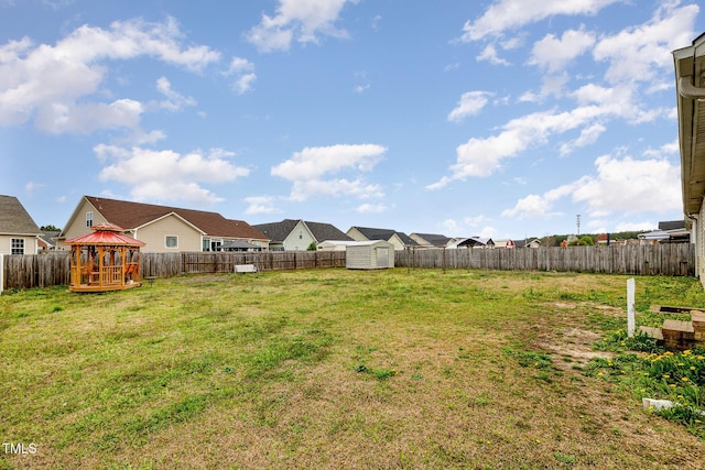 8404 Frenchorn Ln, Fayetteville, NC 28314 - view of yard with a residential view, a gazebo, a fenced backyard, an outbuilding, and a storage unit