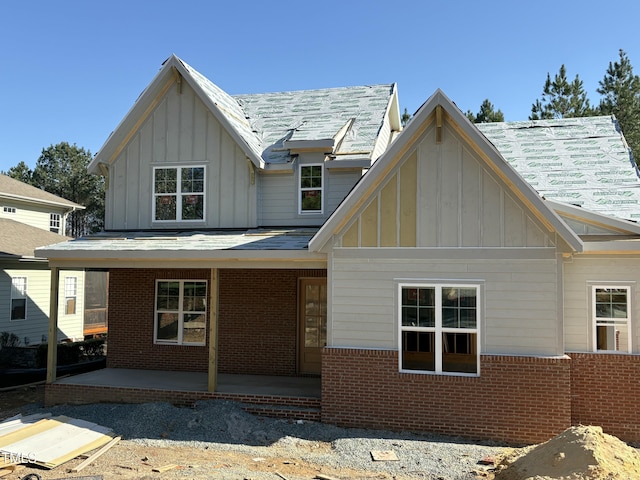 829 Chapel Ridge Dr, Pittsboro, NC 27312 - back of property with brick siding, a patio area, and board and batten siding