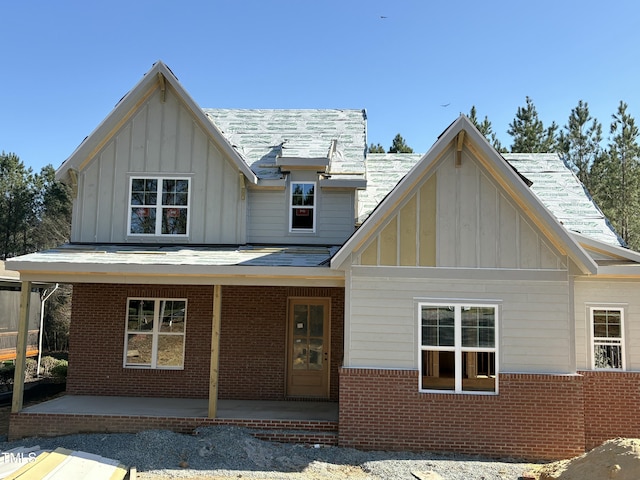829 Chapel Ridge Dr, Pittsboro, NC 27312 - back of property featuring brick siding, board and batten siding, and a porch