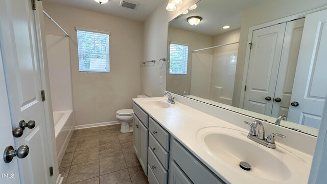 49 W Copenhaver Dr, Clayton, NC 27527 - bathroom featuring plenty of natural light, baseboards, toilet, and double vanity