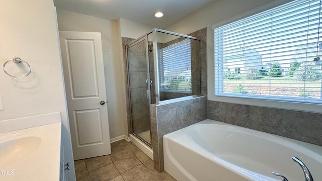 49 W Copenhaver Dr, Clayton, NC 27527 - full bath with tile patterned floors, a shower stall, a garden tub, vanity, and recessed lighting