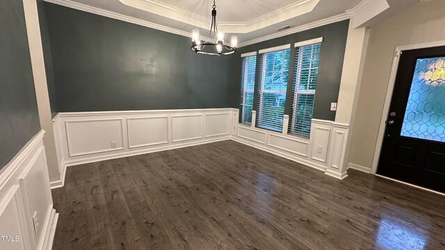 49 W Copenhaver Dr, Clayton, NC 27527 - unfurnished dining area with a decorative wall, a chandelier, a tray ceiling, crown molding, and dark wood finished floors