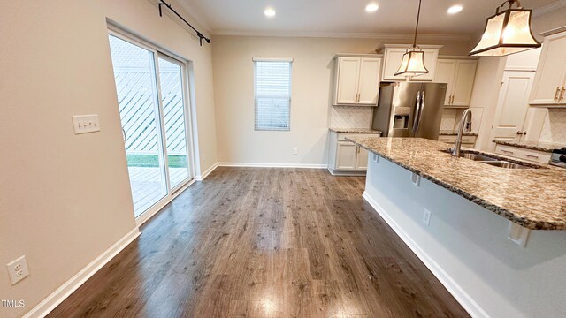 49 W Copenhaver Dr, Clayton, NC 27527 - kitchen with stainless steel fridge with ice dispenser, a sink, tasteful backsplash, plenty of natural light, and recessed lighting