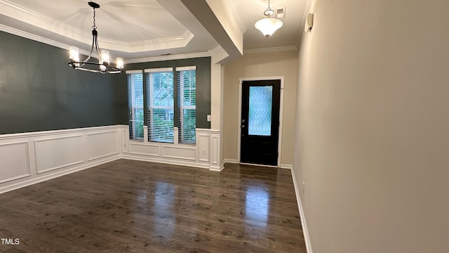 49 W Copenhaver Dr, Clayton, NC 27527 - entrance foyer featuring ornamental molding, dark wood finished floors, a chandelier, a raised ceiling, and wainscoting