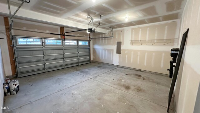 49 W Copenhaver Dr, Clayton, NC 27527 - garage featuring a garage door opener and electric panel