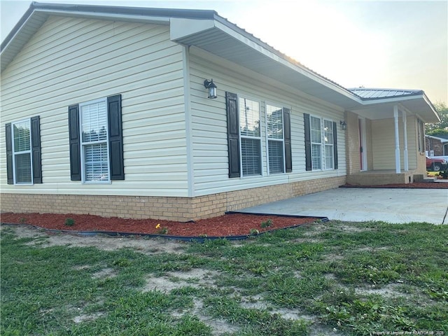 view of property exterior featuring a yard and a patio