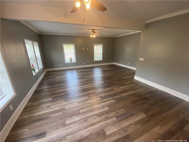 unfurnished room with ornamental molding, dark wood-style floors, baseboards, and ceiling fan