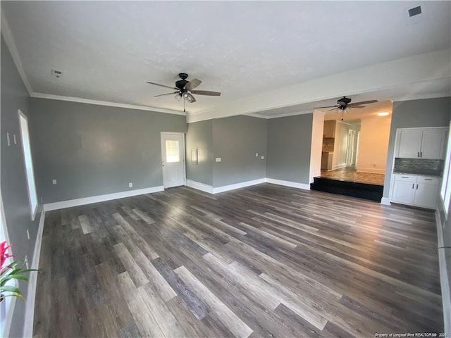 unfurnished living room with dark wood-style floors, visible vents, a ceiling fan, baseboards, and ornamental molding