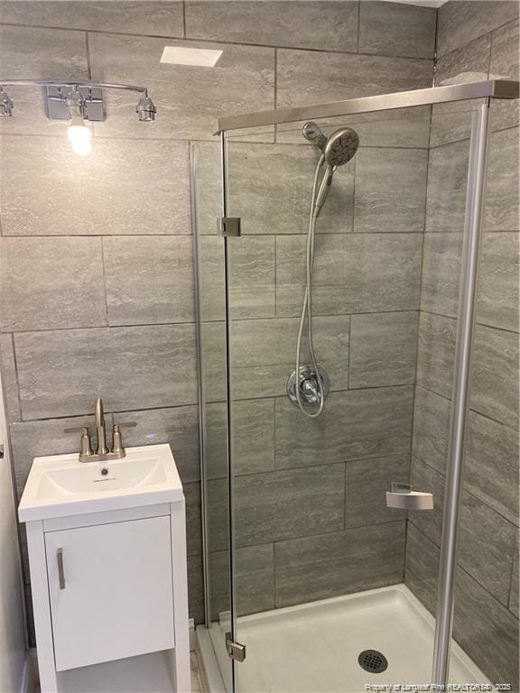 bathroom with a stall shower and vanity