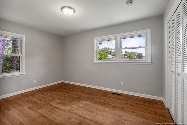 3518 Drayton Rd, Fayetteville, NC 28303 - unfurnished bedroom with a closet, visible vents, multiple windows, and baseboards