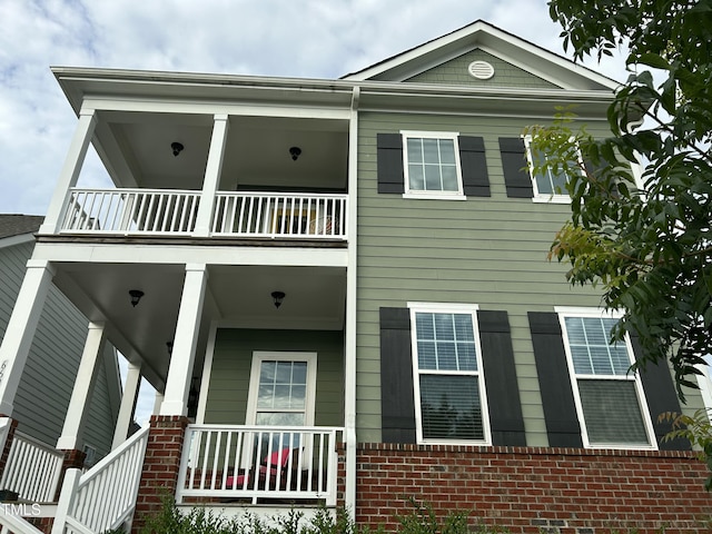 6609 Truxton Ln, Raleigh, NC 27616 - view of front of house featuring a balcony, brick siding, and a porch