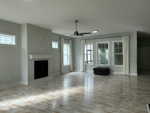 6609 Truxton Ln, Raleigh, NC 27616 - unfurnished living room with ceiling fan, wood finished floors, baseboards, and a fireplace