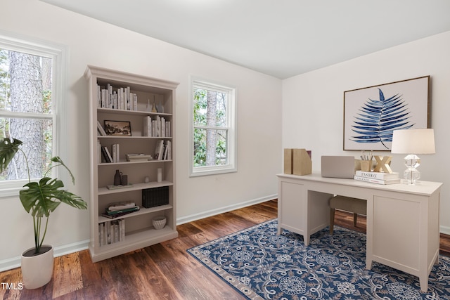 office space featuring baseboards and wood finished floors