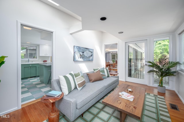 living area featuring visible vents and light wood finished floors