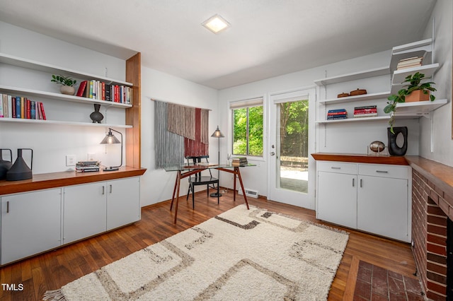 interior space featuring white cabinets, open shelves, and dark wood-style floors