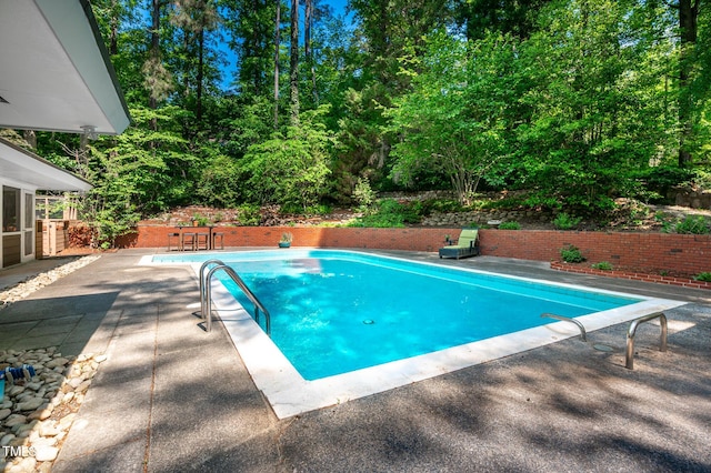 view of pool with a fenced in pool and a patio area