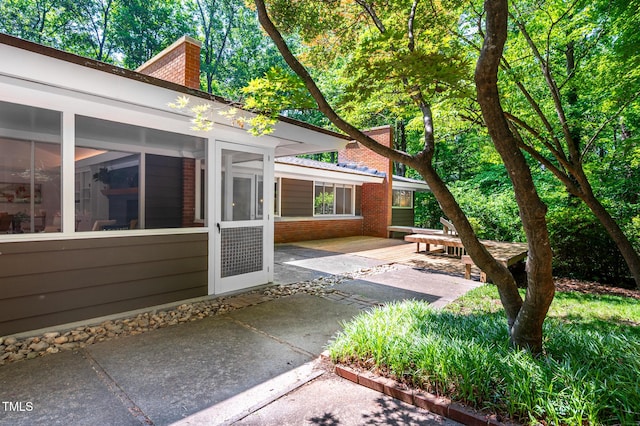 view of patio / terrace featuring a sunroom