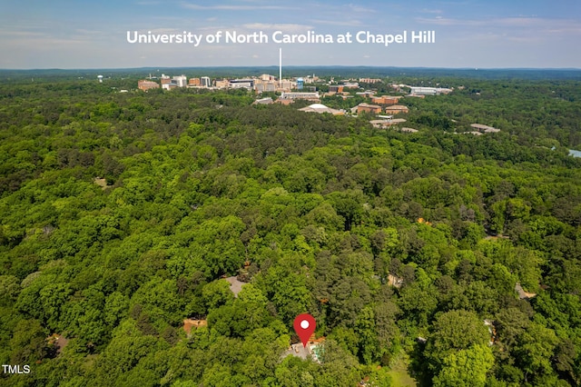 bird's eye view featuring a wooded view