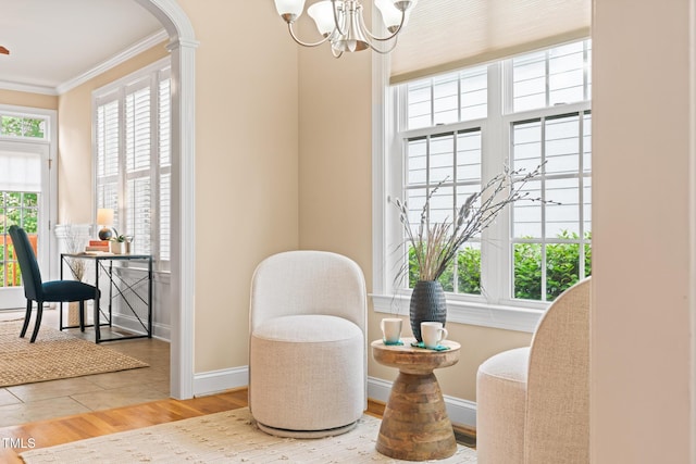 5233 Greymoss Ln, Apex, NC 27539 - sitting room featuring crown molding, a chandelier, baseboards, wood finished floors, and arched walkways
