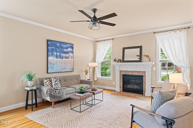 5233 Greymoss Ln, Apex, NC 27539 - living area featuring baseboards, ornamental molding, wood finished floors, a ceiling fan, and a tile fireplace