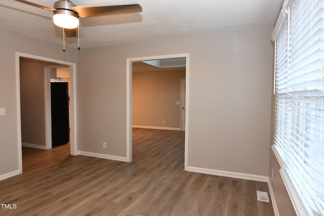 107 Ware Ct, Garner, NC 27529 - spare room featuring a ceiling fan, wood finished floors, a textured ceiling, baseboards, and visible vents