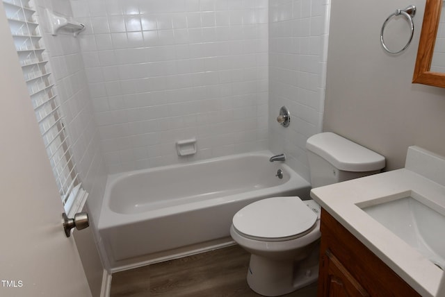 107 Ware Ct, Garner, NC 27529 - bathroom with wood finished floors, toilet, vanity, and washtub / shower combination