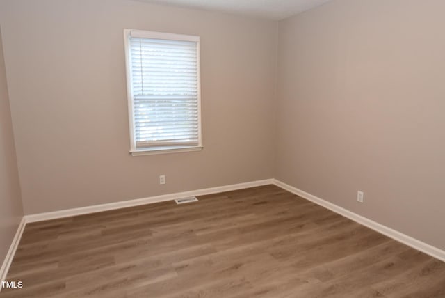 107 Ware Ct, Garner, NC 27529 - spare room with baseboards, visible vents, and wood finished floors