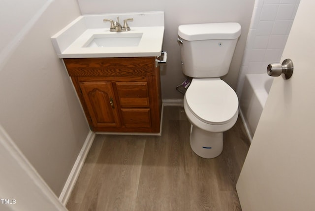 107 Ware Ct, Garner, NC 27529 - bathroom with vanity, a tub, toilet, baseboards, and wood finished floors