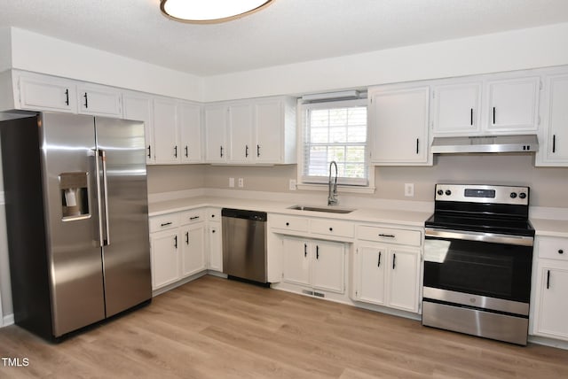 107 Ware Ct, Garner, NC 27529 - kitchen with a sink, light countertops, under cabinet range hood, and appliances with stainless steel finishes