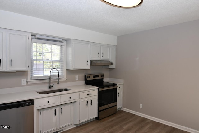 107 Ware Ct, Garner, NC 27529 - kitchen with light countertops, a sink, white cabinetry, appliances with stainless steel finishes, and under cabinet range hood