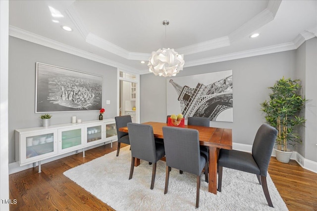 1508 Tradescant Ct, Raleigh, NC 27613 - dining space with a chandelier, wood finished floors, a tray ceiling, crown molding, and recessed lighting