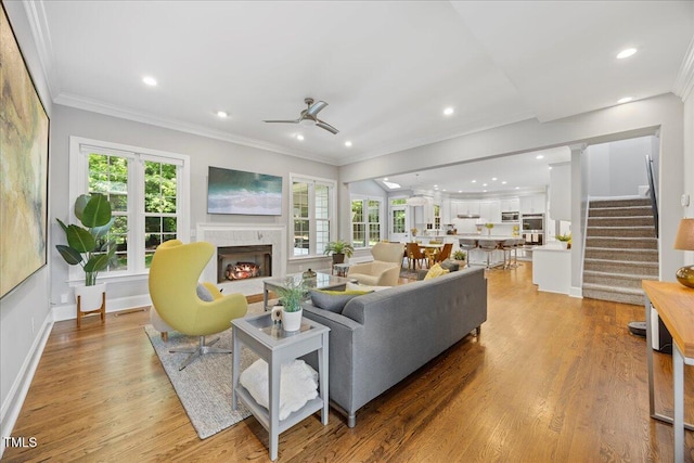 1508 Tradescant Ct, Raleigh, NC 27613 - living area with a high end fireplace, stairs, a ceiling fan, light wood-type flooring, and recessed lighting