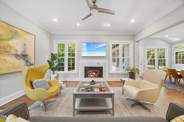 1508 Tradescant Ct, Raleigh, NC 27613 - living area with a warm lit fireplace, wood finished floors, a ceiling fan, recessed lighting, and ornamental molding