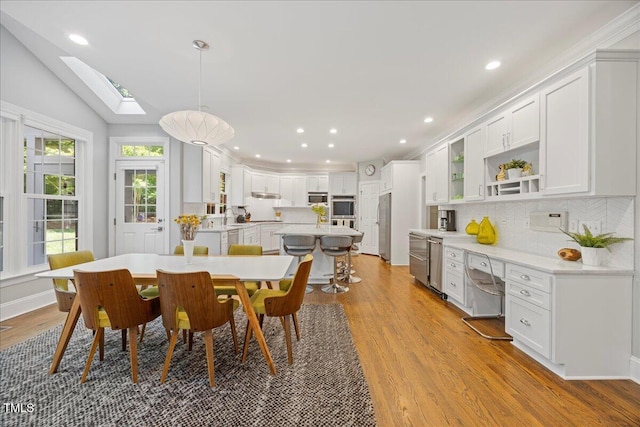 1508 Tradescant Ct, Raleigh, NC 27613 - dining room with a skylight, wood finished floors, and recessed lighting