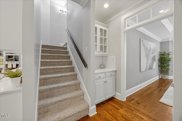 1508 Tradescant Ct, Raleigh, NC 27613 - stairs featuring crown molding, wood finished floors, and recessed lighting