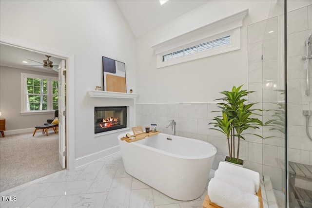 1508 Tradescant Ct, Raleigh, NC 27613 - full bath with a freestanding tub, a tile shower, a ceiling fan, marble finish floors, and a glass covered fireplace