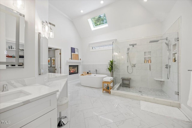 1508 Tradescant Ct, Raleigh, NC 27613 - bathroom featuring a skylight, a shower stall, a freestanding bath, a glass covered fireplace, and vanity