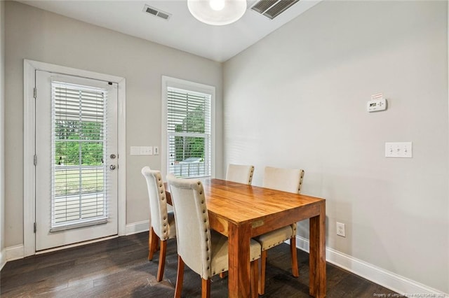 dining area featuring plenty of natural light, baseboards, and dark wood finished floors