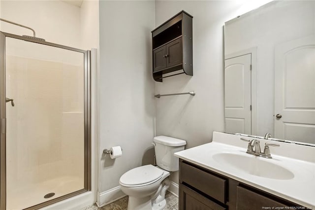 bathroom featuring baseboards, a stall shower, vanity, and toilet