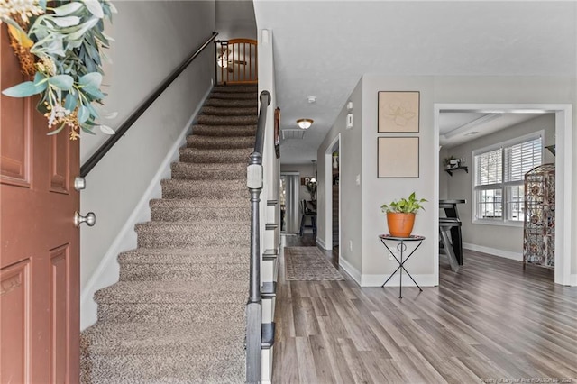 263 Autumn Ln, Raeford, NC 28376 - foyer entrance featuring stairs, wood finished floors, and baseboards