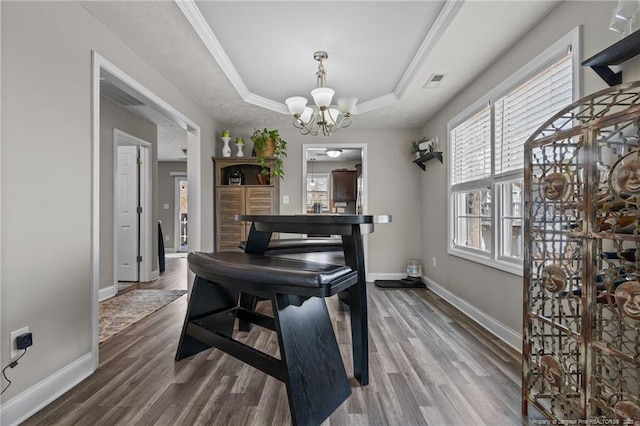 263 Autumn Ln, Raeford, NC 28376 - dining area with a chandelier, a raised ceiling, and dark wood-type flooring