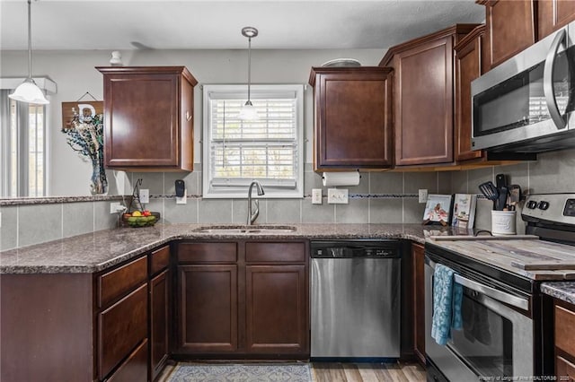 263 Autumn Ln, Raeford, NC 28376 - kitchen featuring stainless steel appliances, a sink, and dark stone countertops